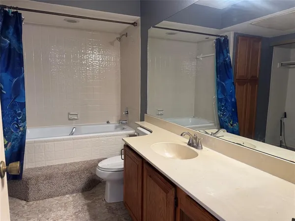 a bathroom with a sink toilet tub and shower