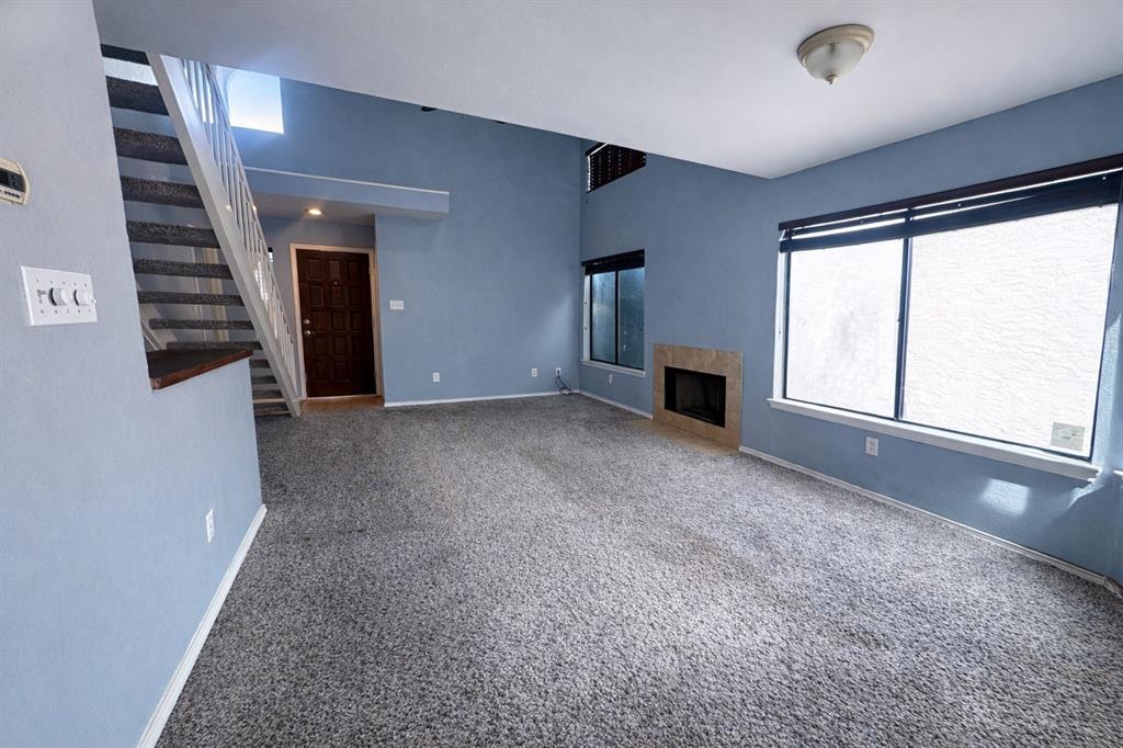 551 Ranch Trail, Unit 197 Irving, TX 75063 - Photo 3 of 14 wooden floor in an empty room with a window