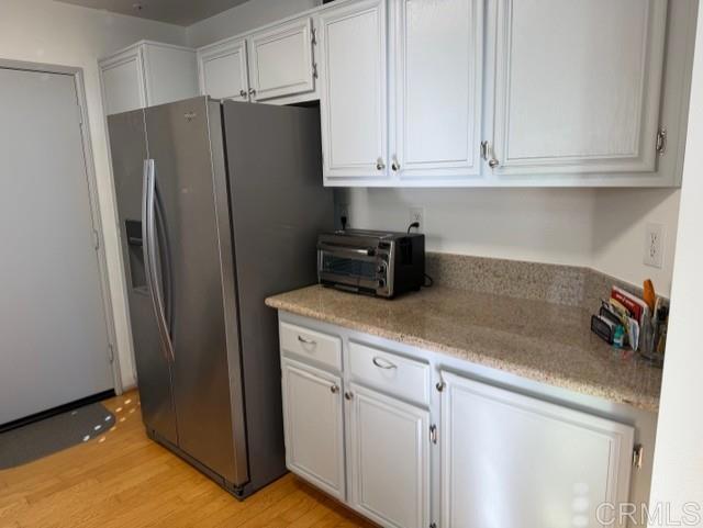 5735 Barbary Place Bonsall, CA 92003 - Photo 15 of 28 a kitchen with stainless steel appliances white cabinets and a refrigerator