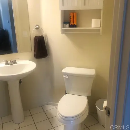 a white toilet sitting next to a bathroom sink
