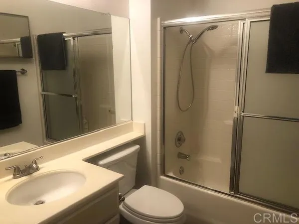 a bathroom with a shower toilet and sink