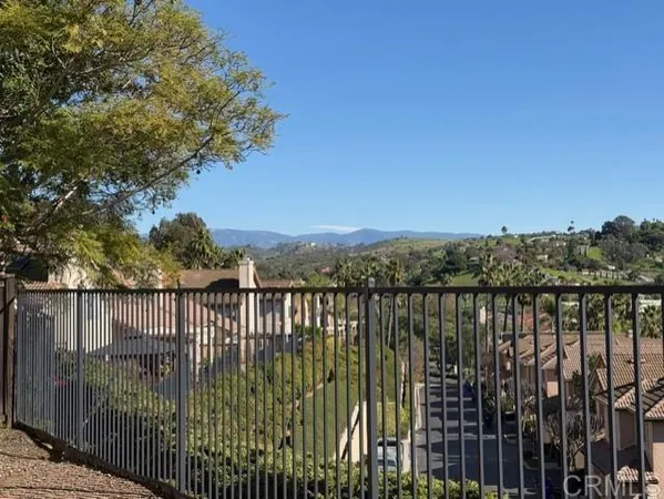 a view of a balcony with wooden fence and floor