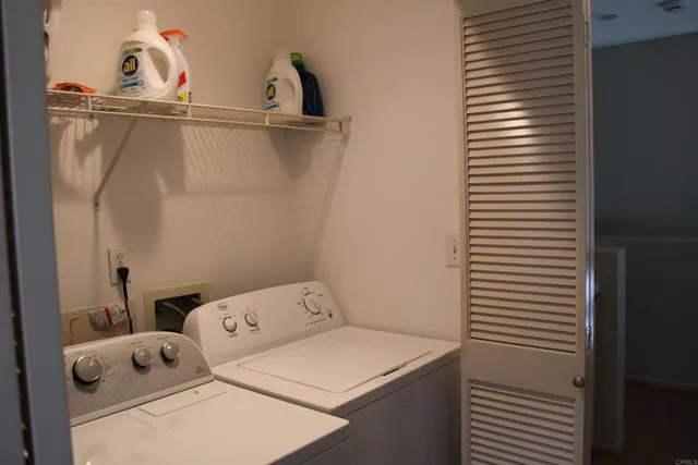a close up of a utility room with dryer and washer