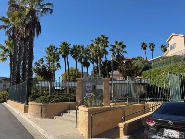 a view of a backyard with swimming pool and sitting area