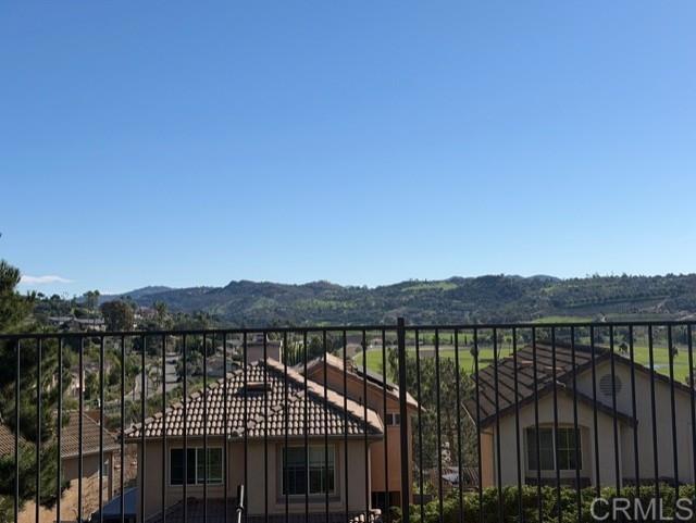 5735 Barbary Place Bonsall, CA 92003 - Photo 4 of 28 a view of a house with wooden fence and a city view