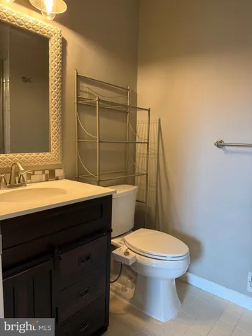 a bathroom with a sink a toilet and mirror