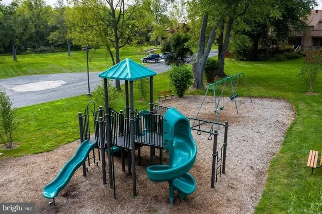 a view of a table and chairs in backyard of the house