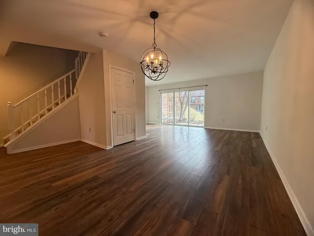 a view of an entryway with wooden floor