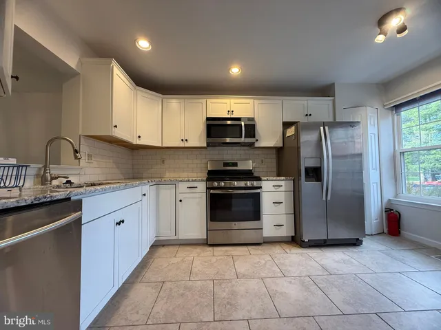 a kitchen with a refrigerator sink and microwave