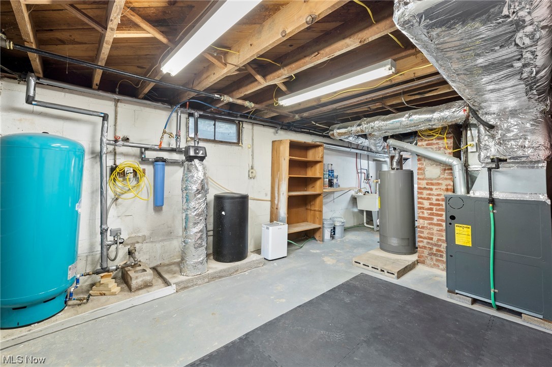227 South Messner Road New Franklin, OH 44319 - Photo 42 of 44 Basement featuring brick wall, water heater, and sink