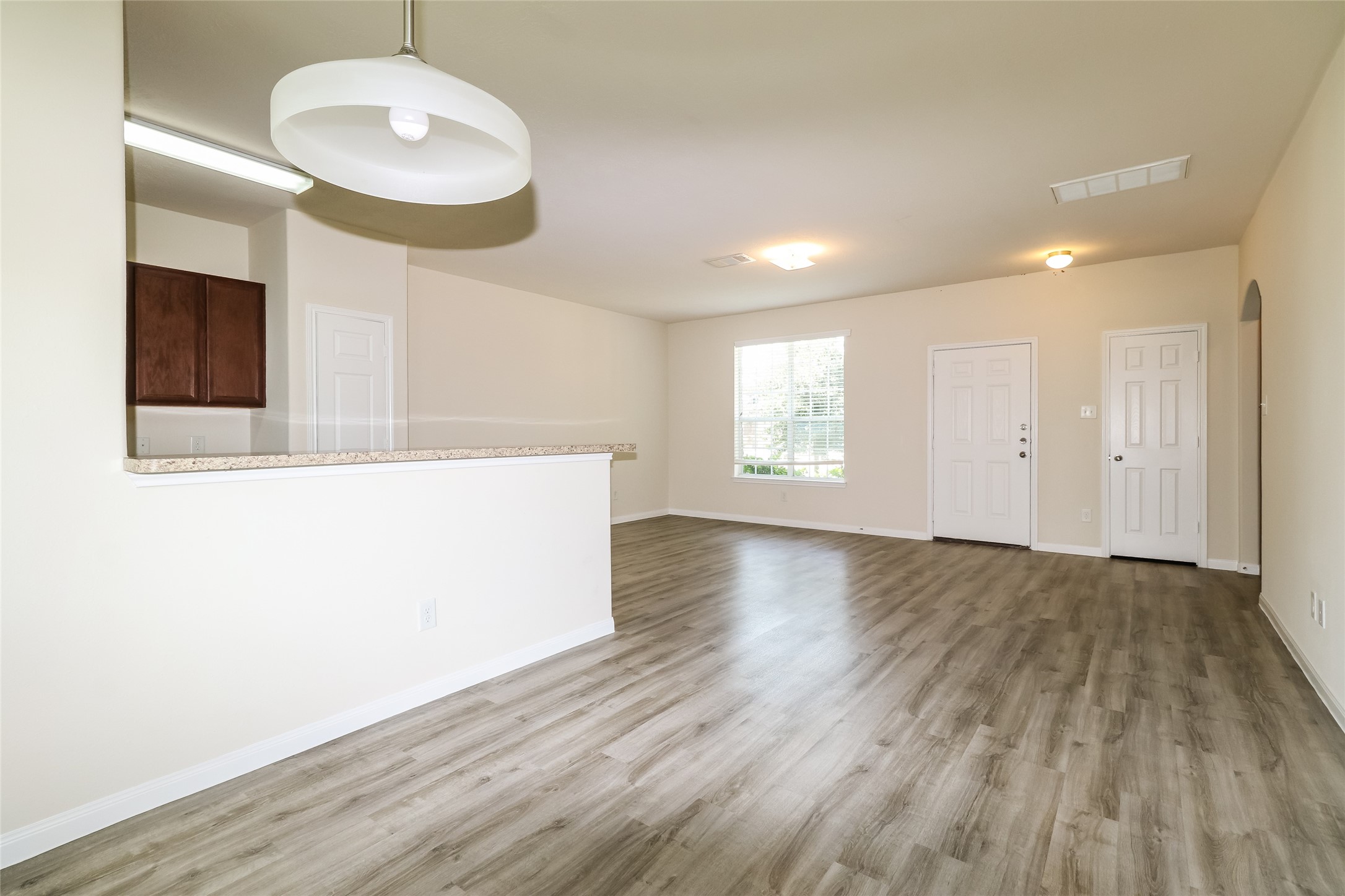 12307 Roy Mix Bohn Lane Houston, TX 77044 - Photo 14 of 17 a view of an empty room with wooden floor and a window