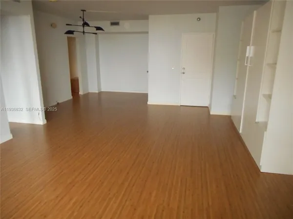 a view of a room with wooden floor