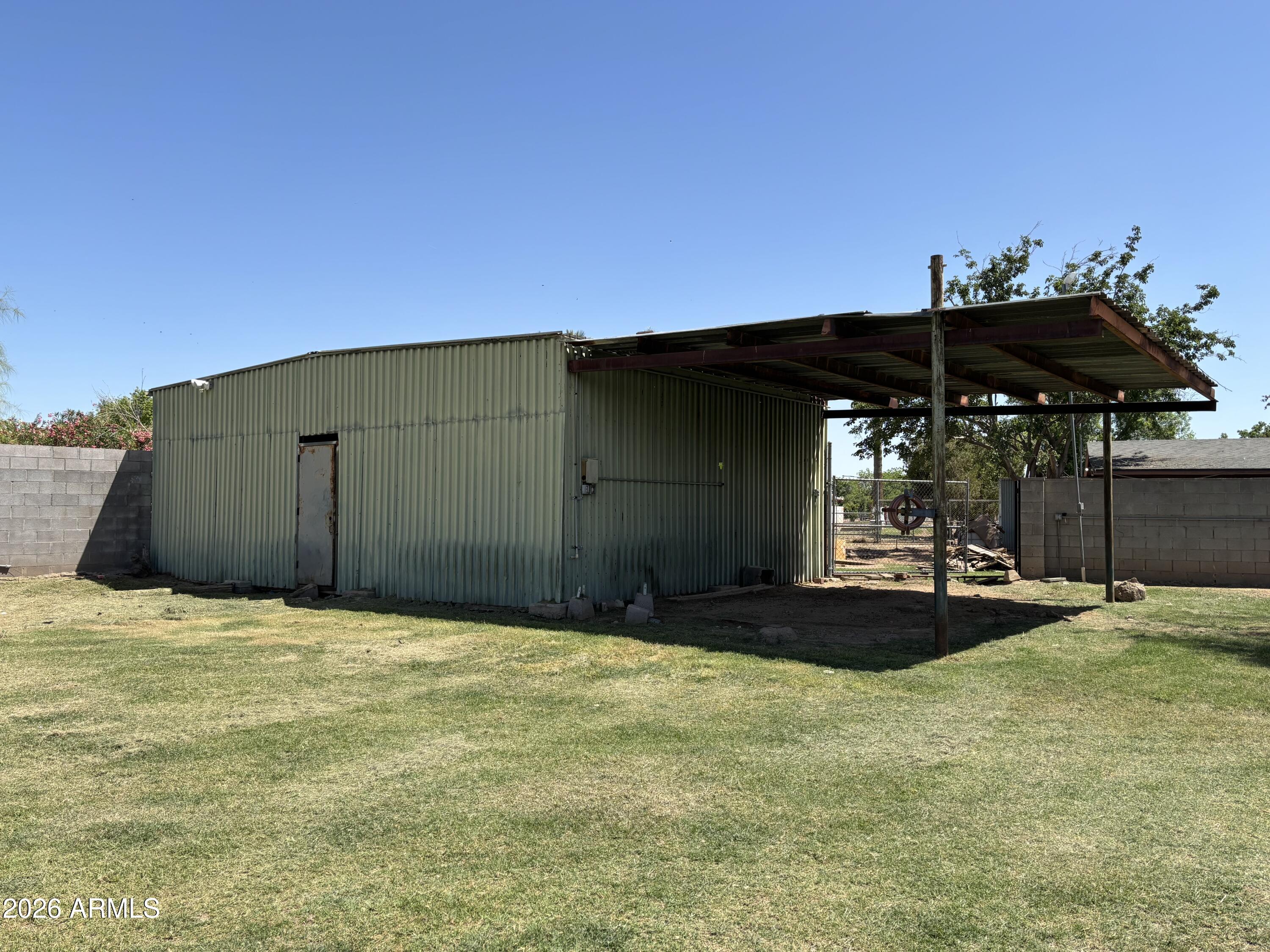 6508 West Fremont Road Laveen, AZ 85339 - Photo 24 of 32 a backyard of a house with table and chairs