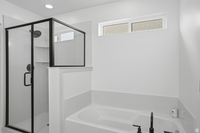 11531 Engelmann Drive Draper, UT 84020 - Photo 17 of 31 Contemporary bathroom featuring a walk-in shower with black-framed glass enclosure, built-in shelving, and a rain showerhead