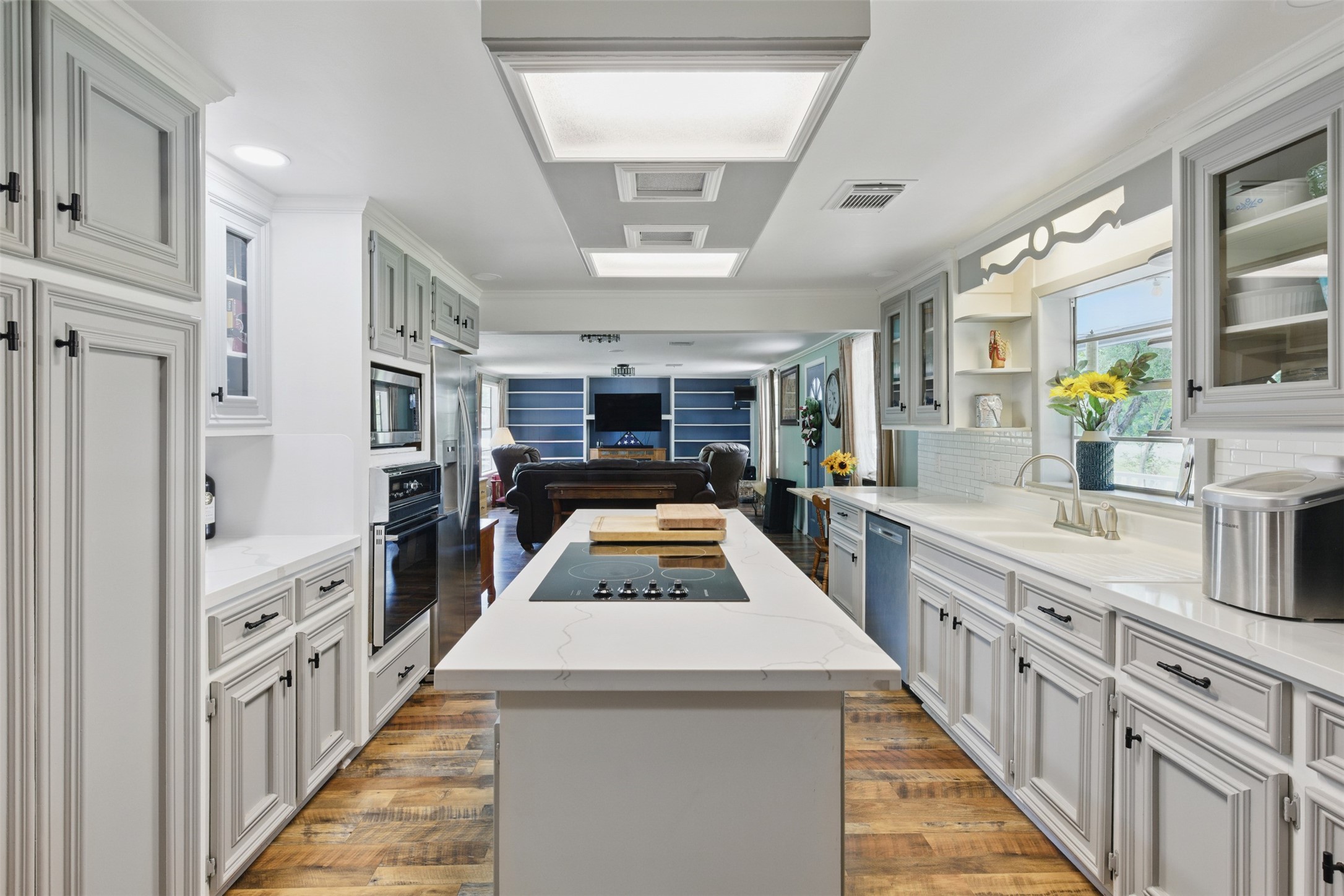 25371 Kickapoo Road Hockley, TX 77447 - Photo 16 of 46 a kitchen with stainless steel appliances kitchen island granite countertop a refrigerator a stove and a sink with cabinets