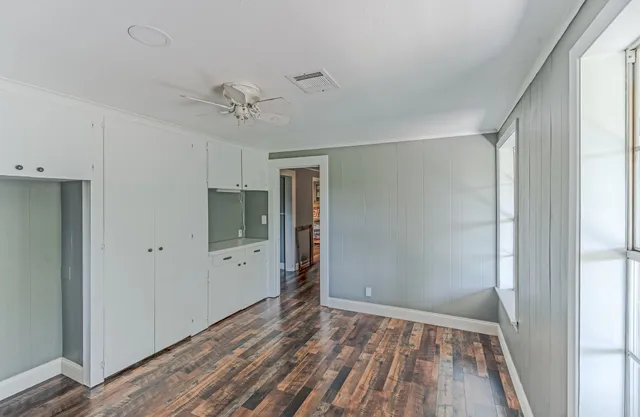 a bathroom with a granite countertop sink a mirror and shower