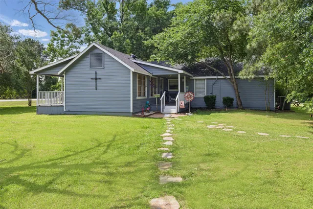 a view of a house with a yard and sitting area