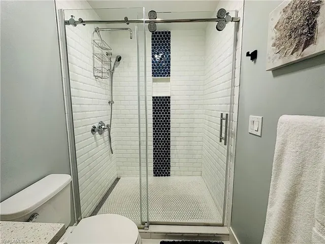 a bathroom with a sink mirror vanity and toilet