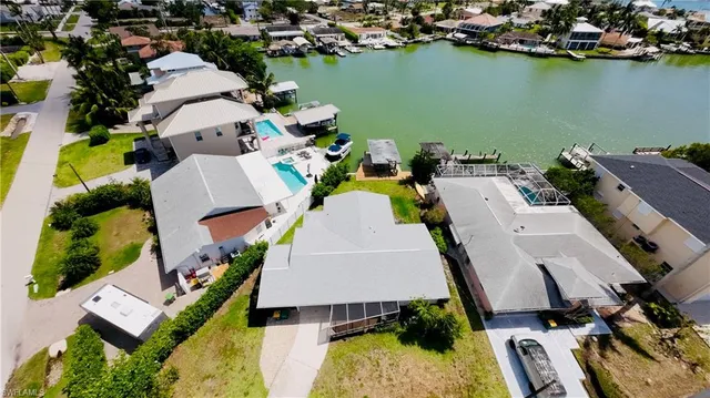 an aerial view of a house with a lake view