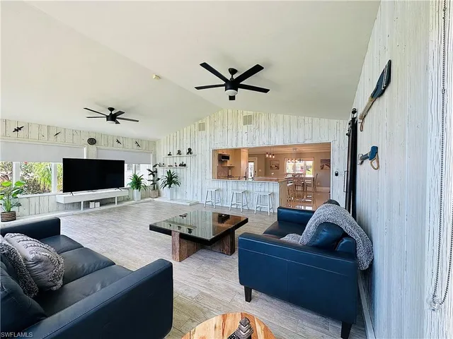 a living room with furniture flat screen tv and a fireplace
