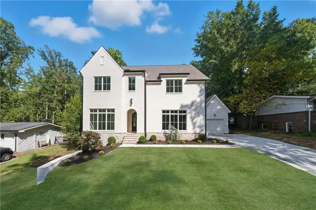 a front view of a house with a yard table and chairs