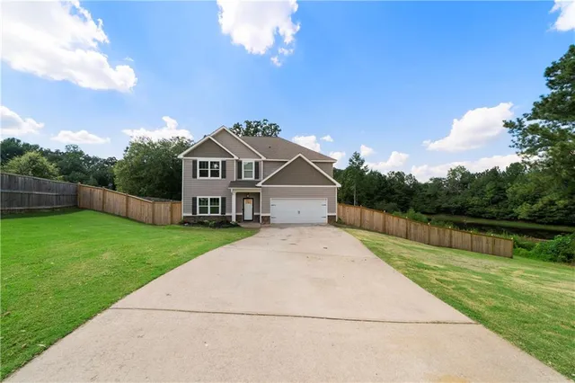 a view of house with yard