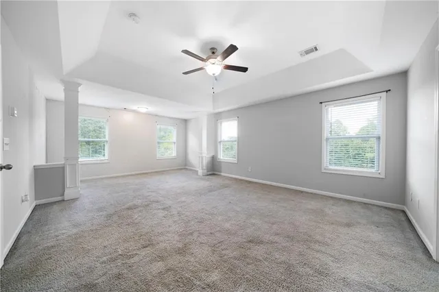 a view of a livingroom with a ceiling fan and window