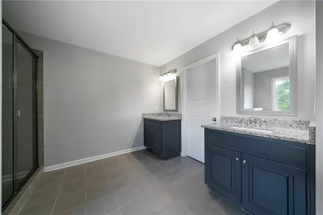 a bathroom with a double vanity sink and mirror