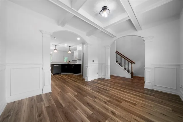 a view of a room with wooden floor