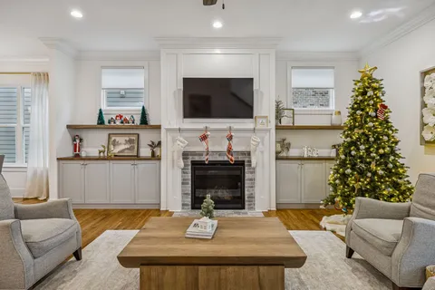a kitchen with kitchen island white cabinets and stainless steel appliances