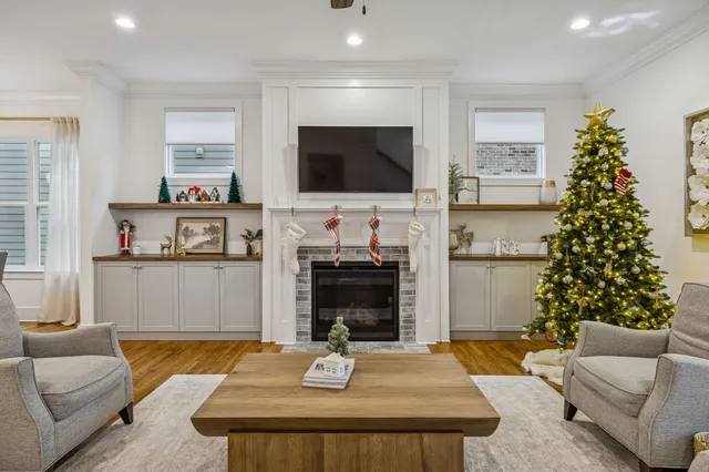 a kitchen with kitchen island white cabinets and stainless steel appliances