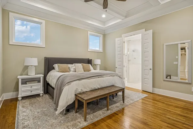 a bedroom with a bed and painting on the wall