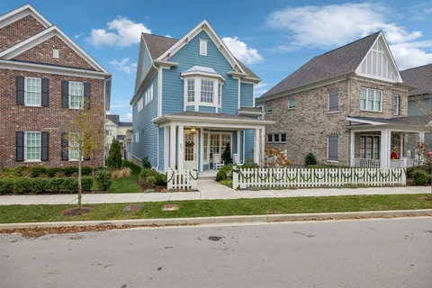 front view of a brick house with a small yard