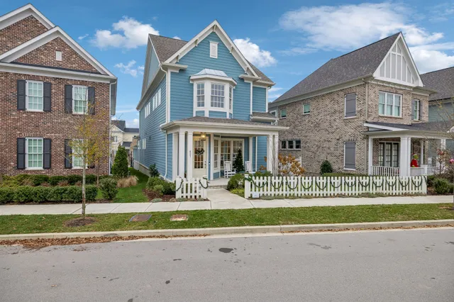 front view of a brick house with a small yard