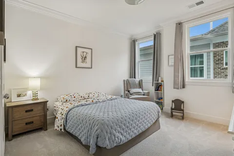 an aerial view of residential houses with outdoor space and lake view