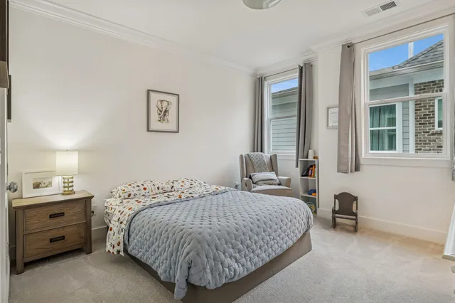 an aerial view of residential houses with outdoor space and lake view