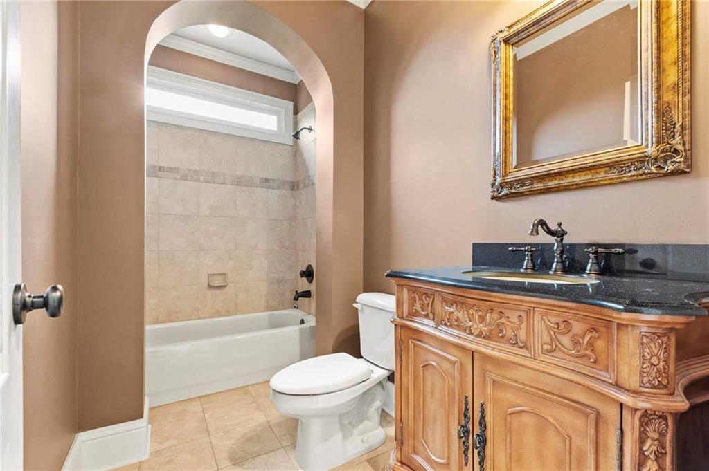2602 Alcovy Club Drive Dacula, GA 30019 - Photo 14 of 44 a bathroom with a sink a toilet and a bathtub