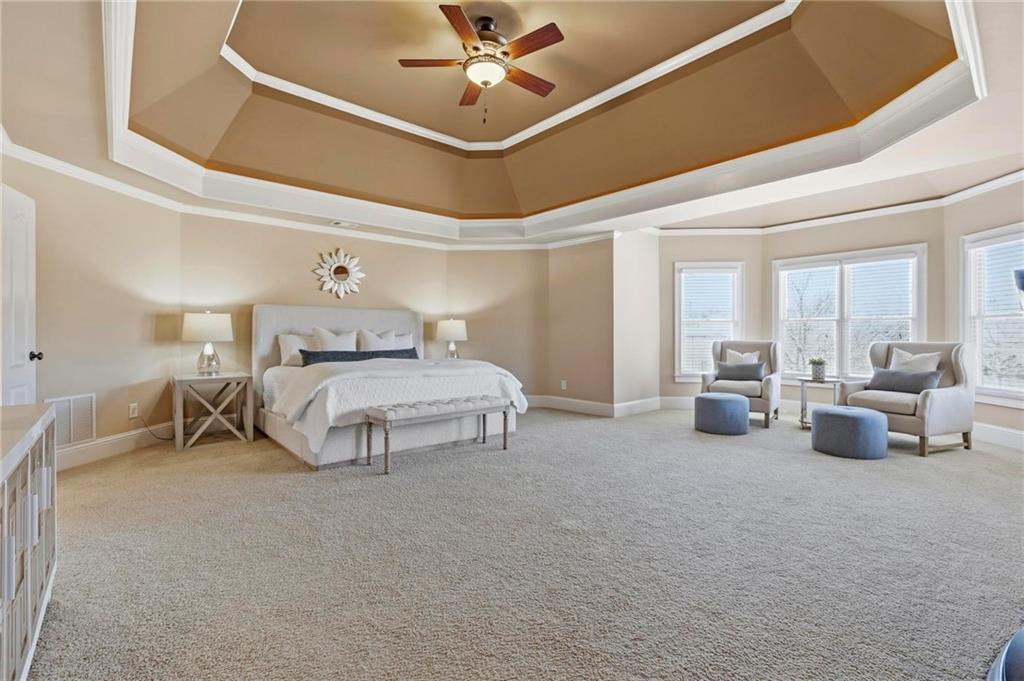 2602 Alcovy Club Drive Dacula, GA 30019 - Photo 16 of 44 a bedroom with furniture and a ceiling fan