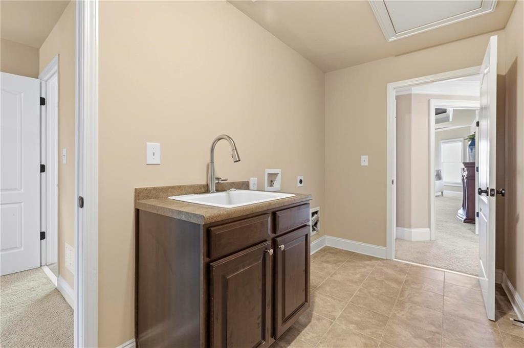 2602 Alcovy Club Drive Dacula, GA 30019 - Photo 23 of 44 a bathroom with a sink and mirror