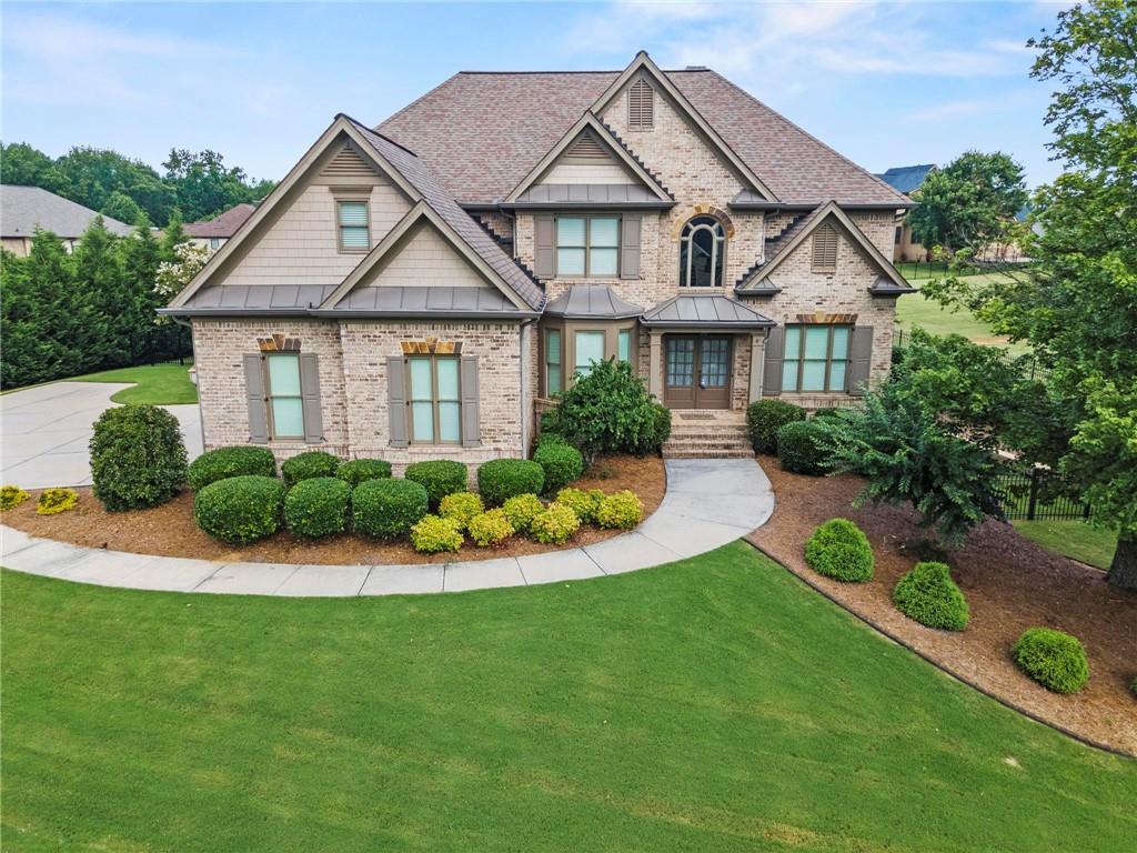 2602 Alcovy Club Drive Dacula, GA 30019 - Photo 41 of 44 a front view of a house with a yard and potted plants