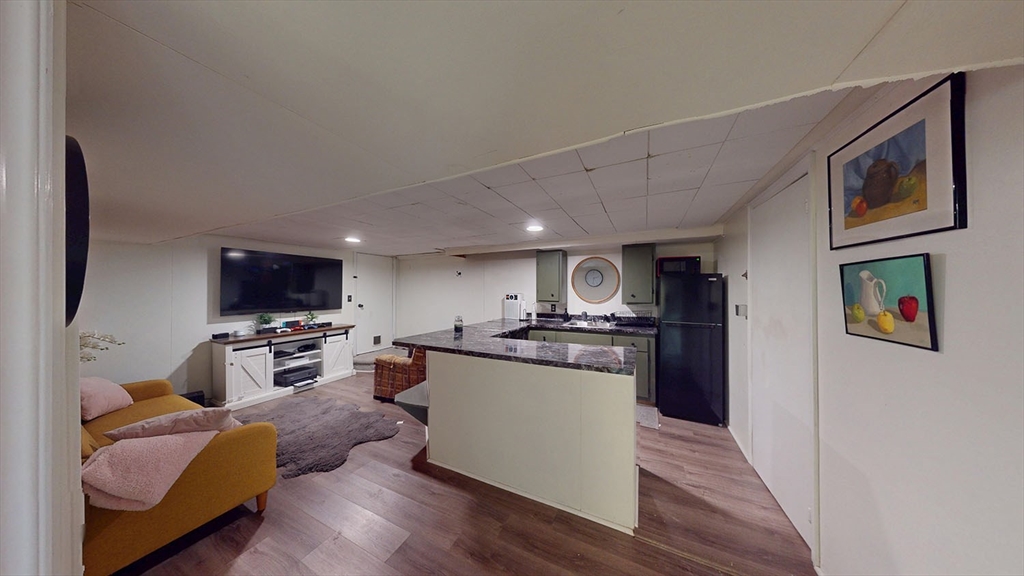 706 Mohawk Road Somerset, MA 02726 - Photo 26 of 33 a kitchen with stainless steel appliances granite countertop a refrigerator a stove top oven a sink dishwasher and wooden cabinets