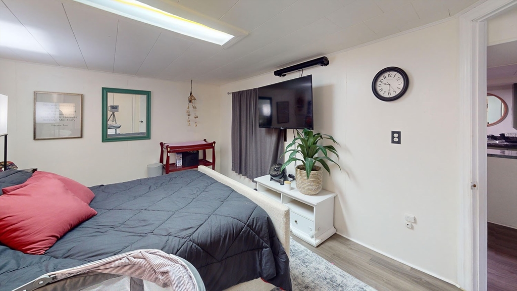 706 Mohawk Road Somerset, MA 02726 - Photo 28 of 33 a bedroom with a bed and a potted plant