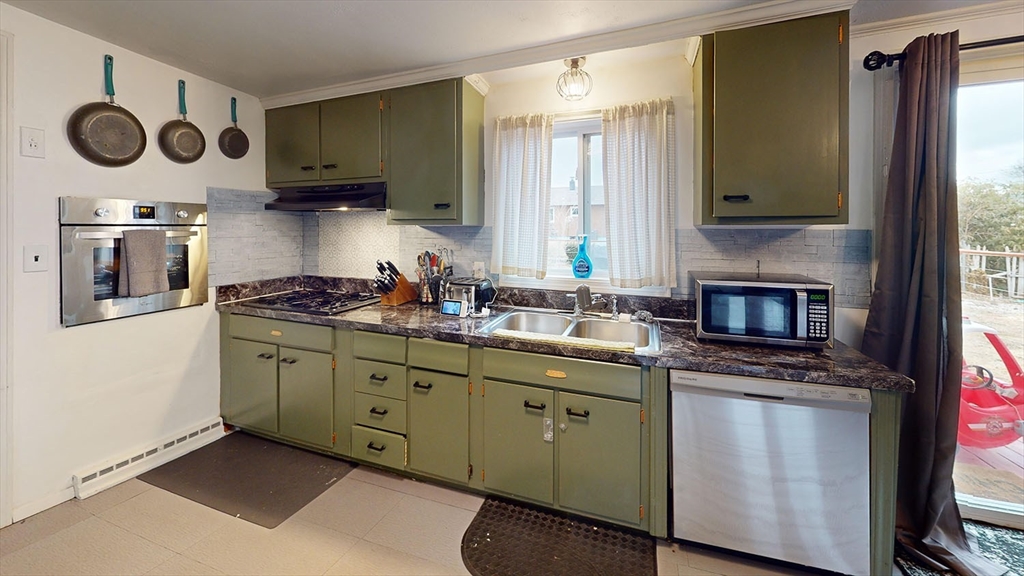 706 Mohawk Road Somerset, MA 02726 - Photo 7 of 33 a kitchen with stainless steel appliances a stove a sink and a microwave
