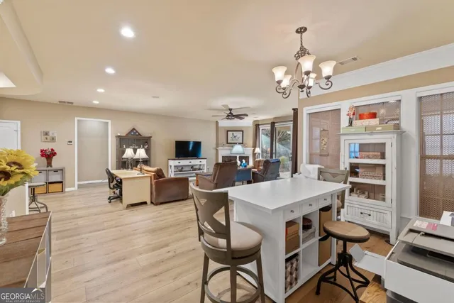 a large kitchen with a table and chairs