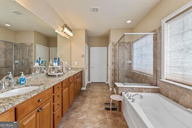 a bedroom with a bed a table and chair