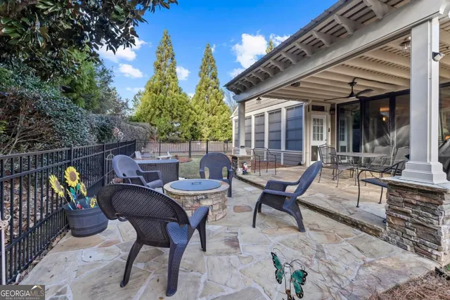 a view of a patio with couple of chairs and a fountain
