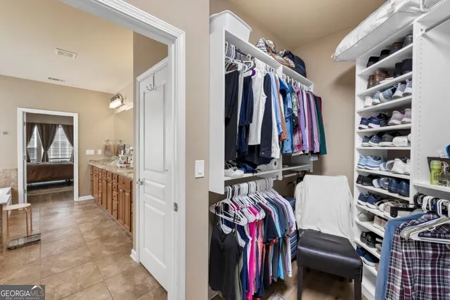 a view of a workspace with furniture and a large window