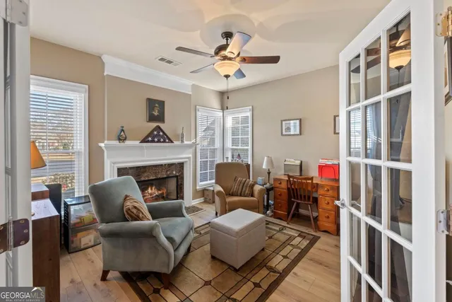 a living room with furniture a fireplace and a large window