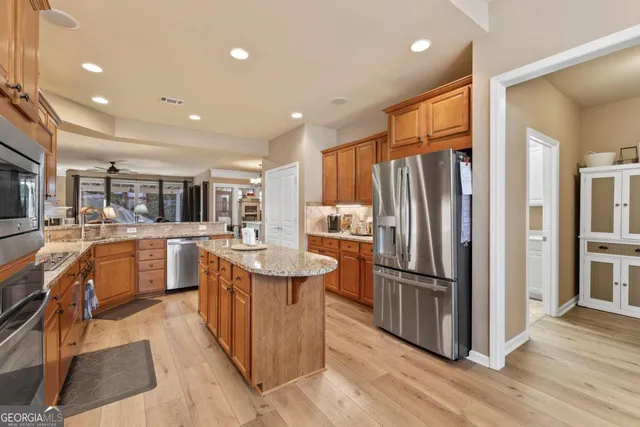 a kitchen with counter top space refrigerator sink and center island