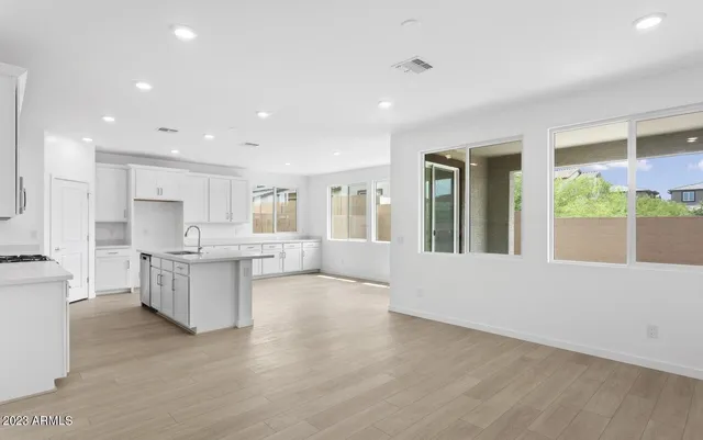 a large white kitchen with a large window